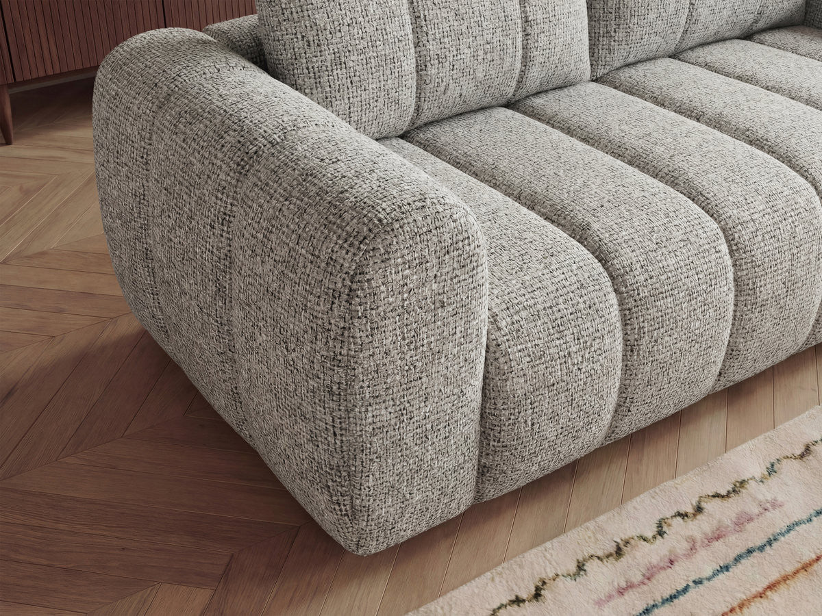 L-hjørnesofa NESTY i melert stoff med puff